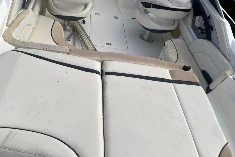 Slide: The Image of 2007 Monterey 234FSX boat interior with white and beige seating. - 8