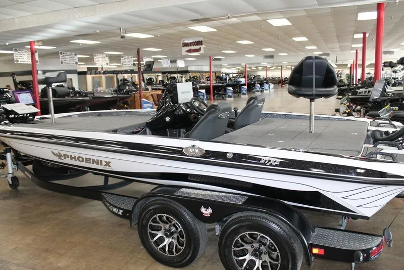Slide: The Image of 2026 Phoenix 21 XE boat displayed indoors, featuring sleek design and modern seating. - 10