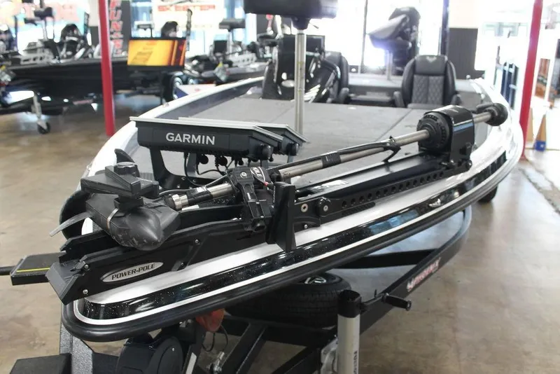 Slide: The Image of 2026 Phoenix 21 XE boat with Garmin equipment and Power-Pole, displayed in showroom. - 11