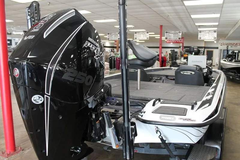 Slide: The Image of 2026 Phoenix 21 XE boat with Mercury Pro XS 250 engine in showroom. - 5