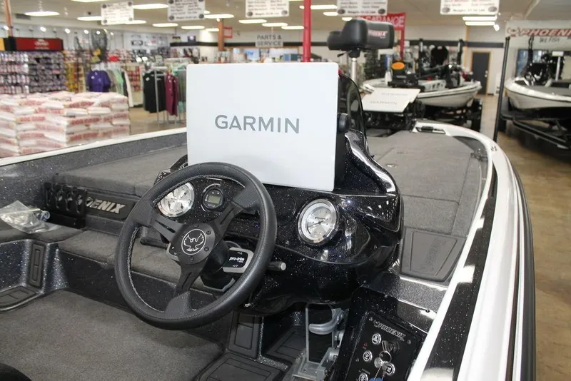 Slide: The Image of 2026 Phoenix 21 XE boat interior with Garmin navigation system in showroom. - 6