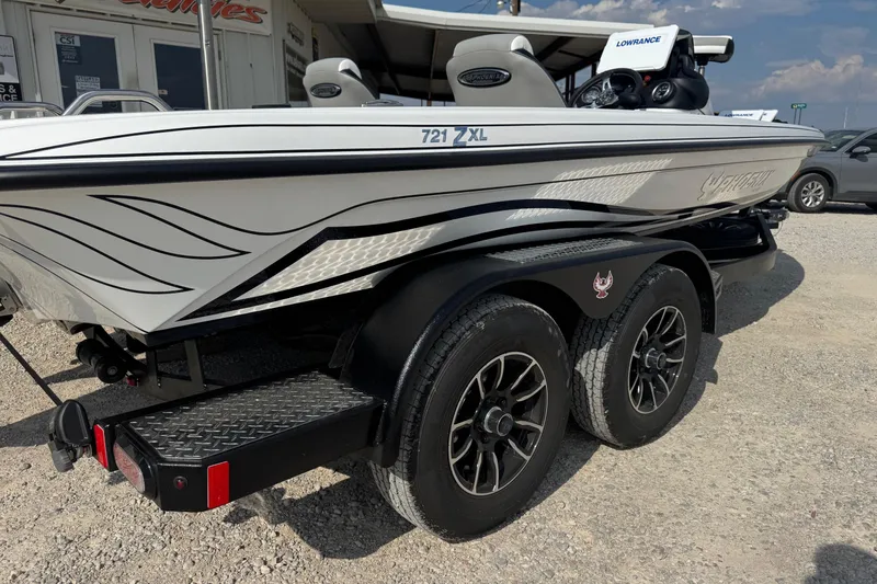 Slide: The Image of 2026 Phoenix 721 ZXL boat on trailer, featuring sleek design and dual wheels. - 10
