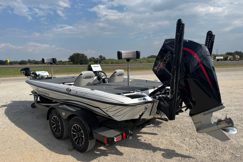 Slide: The Image of 2026 Phoenix 721 ZXL boat with powerful engine, parked on gravel under a cloudy sky. - 3