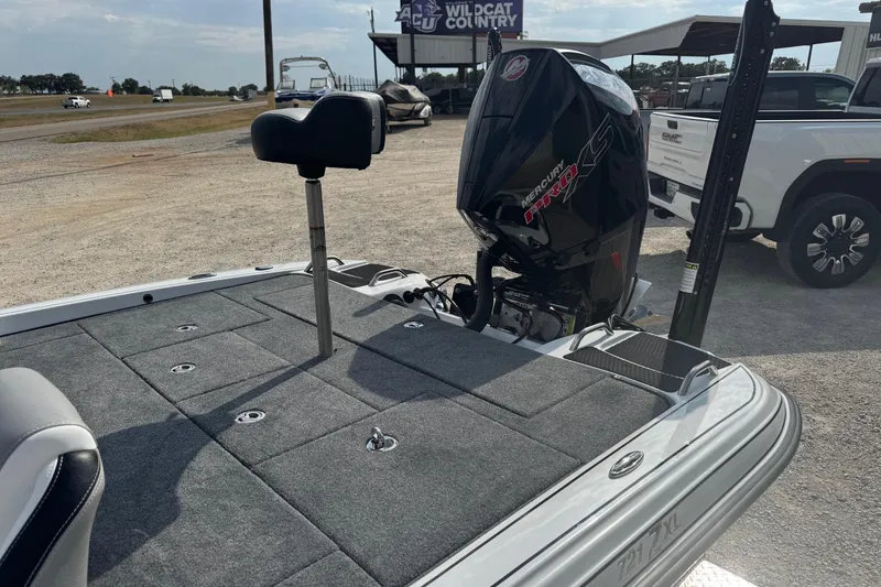 Slide: The Image of 2026 Phoenix 721 ZXL boat with Mercury Pro XS engine, parked outdoors. - 7