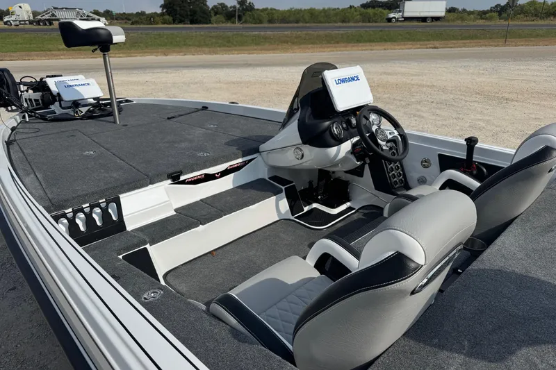 Slide: The Image of 2026 Phoenix 721 ZXL boat interior with modern dashboard and seating, featuring Lowrance electronics. - 8