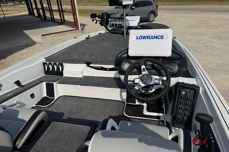 Slide: The Image of 2026 Phoenix 721 ZXL boat interior with Lowrance electronics and modern steering console. - 9