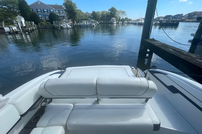 Slide: The Image of 2016 Formula 310 Bowrider docked in a serene marina setting. - 11