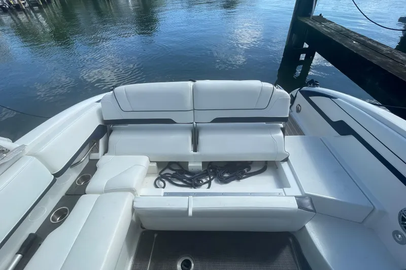 Slide: The Image of 2016 Formula 310 Bowrider boat interior with white seating and storage compartment. - 13