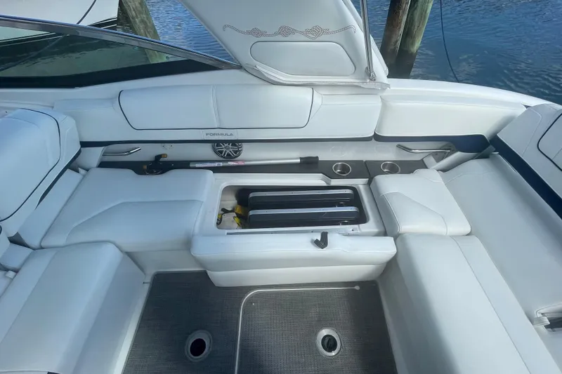 Slide: The Image of 2016 Formula 310 Bowrider interior with white seating and storage compartment. - 14