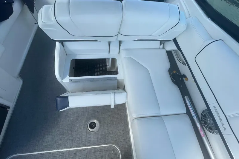 Slide: The Image of 2016 Formula 310 Bowrider interior with white seating and storage compartment. - 17