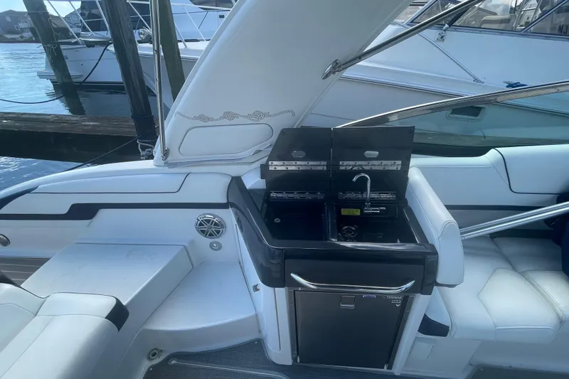 Slide: The Image of 2016 Formula 310 Bowrider boat interior with kitchenette and seating area. - 21