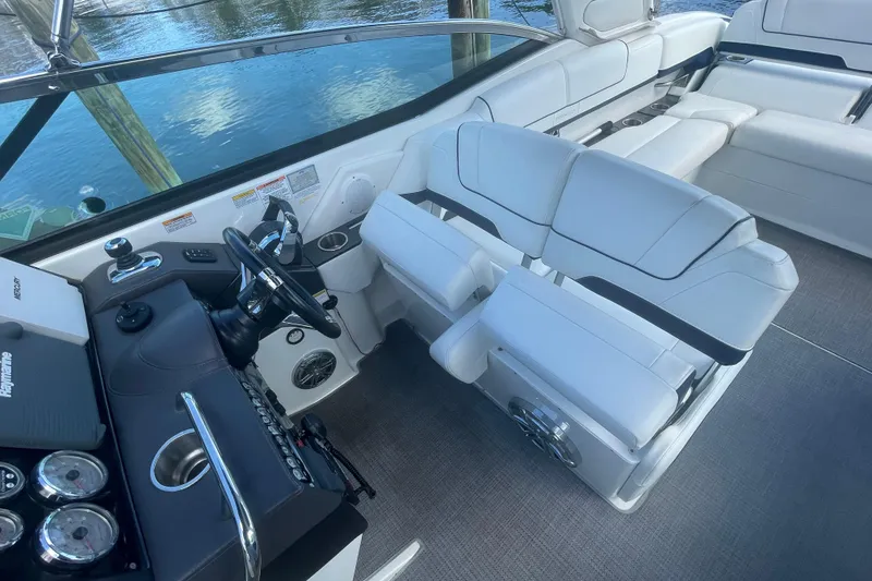 Slide: The Image of 2016 Formula 310 Bowrider interior with white seating and modern dashboard controls. - 24