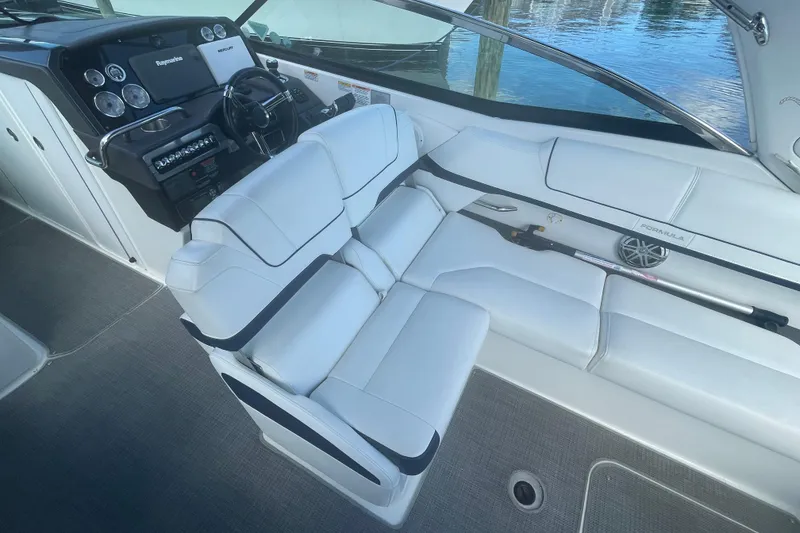 Slide: The Image of 2016 Formula 310 Bowrider interior with white seating and modern dashboard controls. - 26