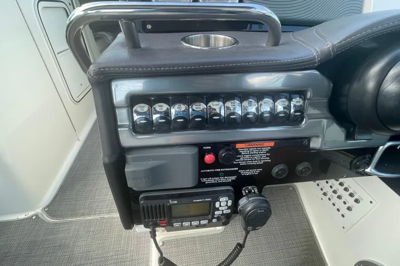 Slide: The Image of Control panel of a 2016 Formula 310 Bowrider boat with switches and radio. - 28