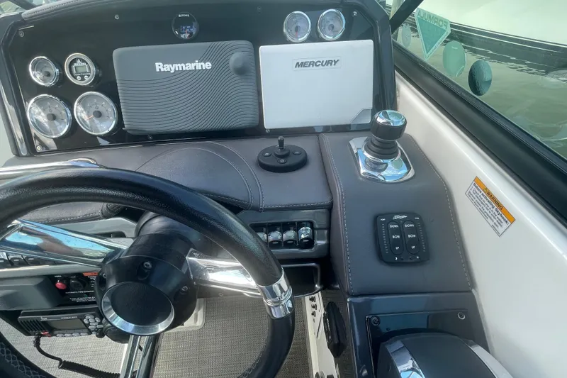 Slide: The Image of 2016 Formula 310 Bowrider dashboard with steering wheel, Raymarine and Mercury controls. - 30