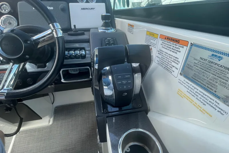 Slide: The Image of Control panel of a 2016 Formula 310 Bowrider boat with steering wheel and throttle. - 31