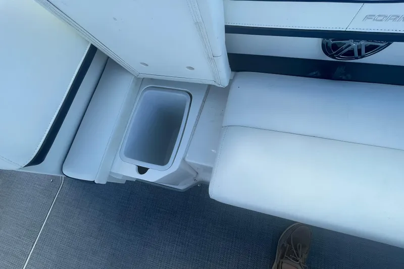 Slide: The Image of 2016 Formula 310 Bowrider interior with white seating and built-in storage compartment. - 35
