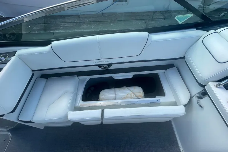 Slide: The Image of 2016 Formula 310 Bowrider interior with open storage compartment and white seating. - 36