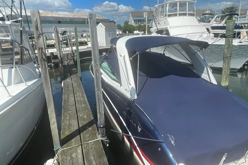 Slide: The Image of 2016 Formula 310 Bowrider docked at marina under blue sky. - 4