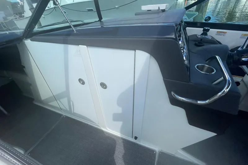 Slide: The Image of 2016 Formula 310 Bowrider interior cockpit with steering wheel and storage compartments. - 49