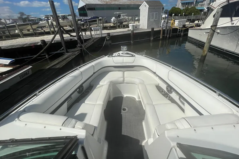 Slide: The Image of 2016 Formula 310 Bowrider boat with spacious seating at a marina dock. - 51