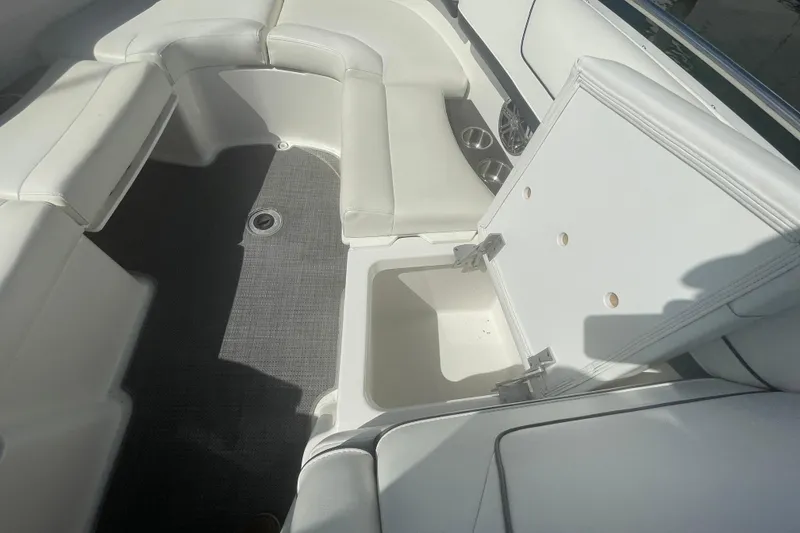 Slide: The Image of 2016 Formula 310 Bowrider interior with white seating and open storage compartment. - 52