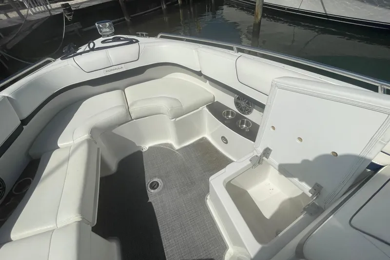Slide: The Image of 2016 Formula 310 Bowrider interior with white seating and open storage compartment. - 53