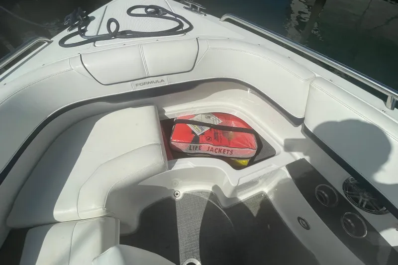 Slide: The Image of 2016 Formula 310 Bowrider interior with life jackets and seating area. - 54