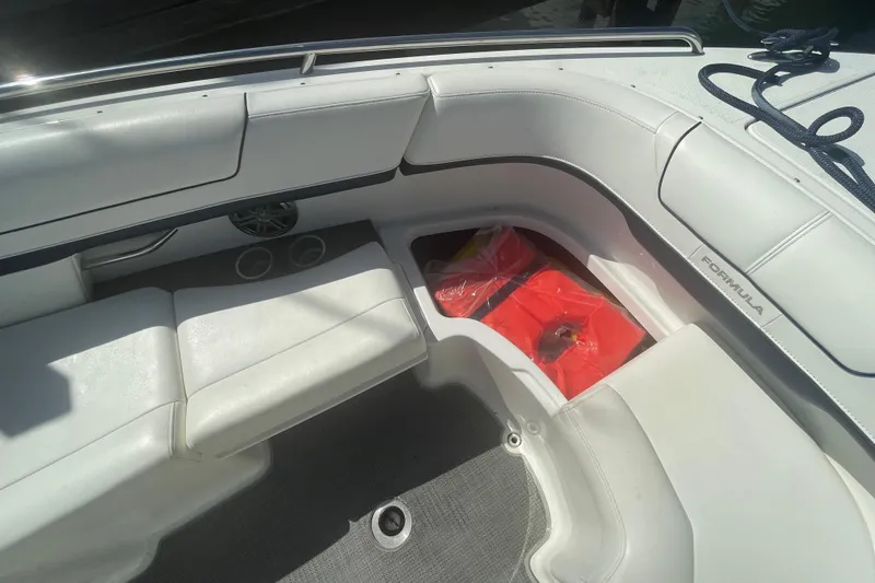 Slide: The Image of 2016 Formula 310 Bowrider interior with white seating and life jackets stored. - 55