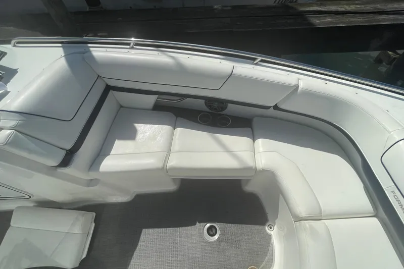 Slide: The Image of 2016 Formula 310 Bowrider interior with white cushioned seating and cup holders. - 56