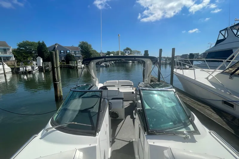 Slide: The Image of 2016 Formula 310 Bowrider docked at marina under clear blue sky. - 65