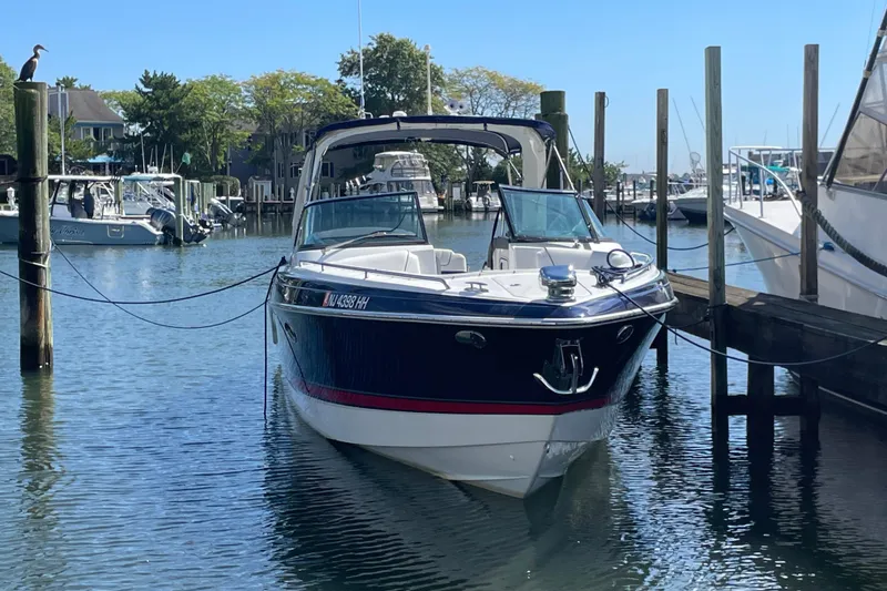 Slide: The Image of 2016 Formula 310 Bowrider docked in a marina, surrounded by other boats. - 69
