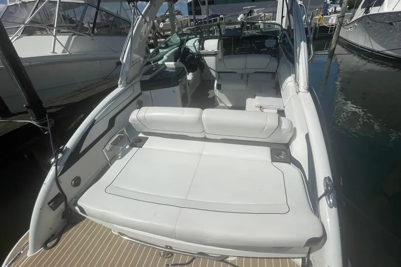 Slide: The Image of 2016 Formula 310 Bowrider boat with spacious seating and sleek design at a marina. - 7