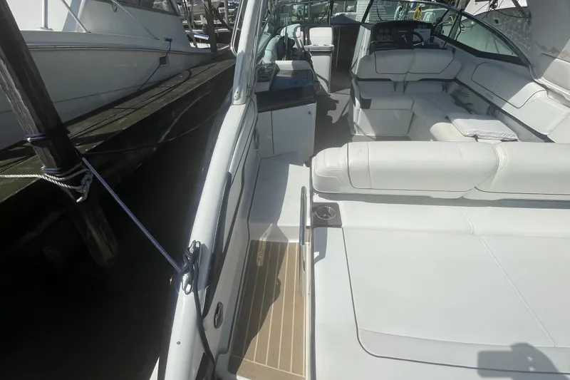 Slide: The Image of 2016 Formula 310 Bowrider with white seating, docked at marina. - 9