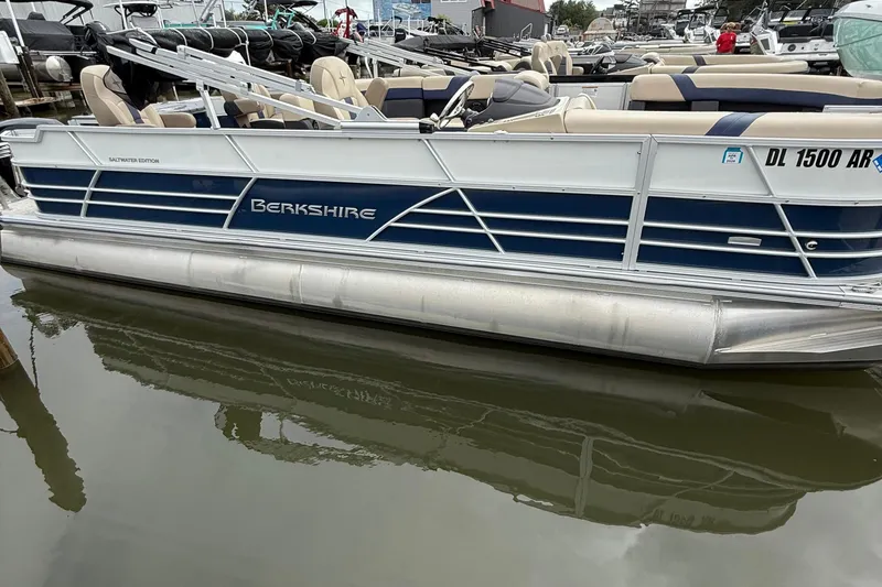 Slide: The Image of 2025 Berkshire 24RFC CTS 2.75 pontoon boat docked in marina. - 3