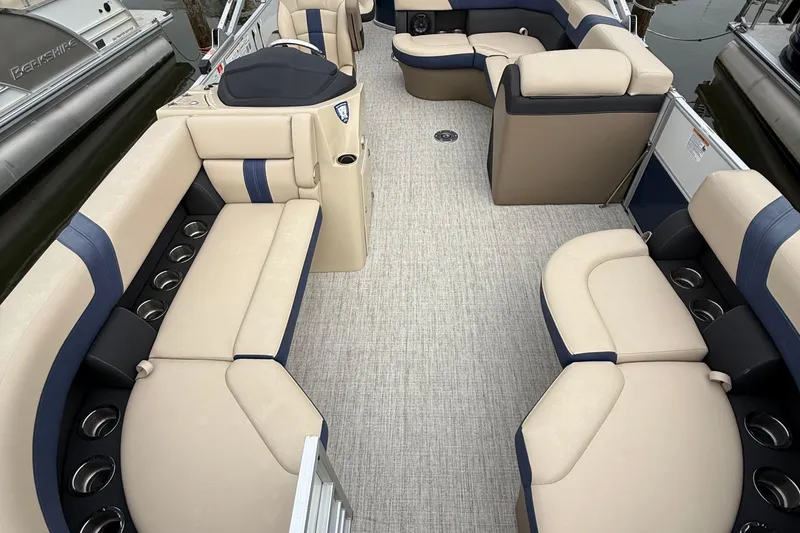 Slide: The Image of Interior of 2025 Berkshire 24RFC CTS 2.75 pontoon boat with beige and blue seating. - 4