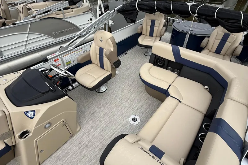 Slide: The Image of 2025 Berkshire 24RFC CTS 2.75 pontoon boat interior with beige and blue seating. - 5