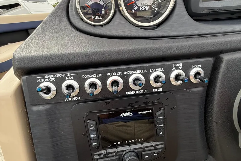 Slide: The Image of Control panel of 2025 Berkshire 24RFC CTS 2.75 boat with switches and gauges. - 9