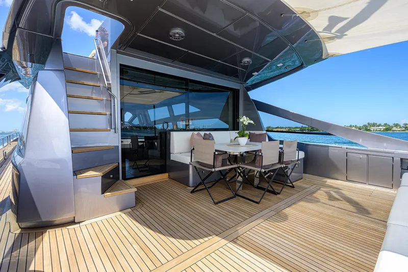 Slide: The Image of Luxurious 2022 Pershing 9X yacht deck with elegant seating and ocean view. - 14
