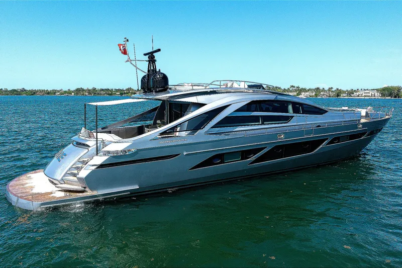 Slide: The Image of 2022 Pershing 9X luxury yacht cruising on open water under cloudy skies. - 2