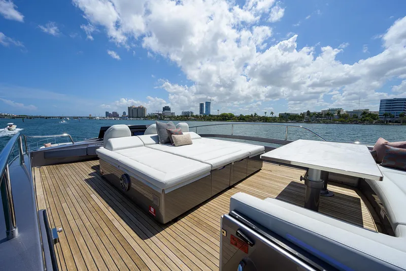 Slide: The Image of Luxurious 2022 Pershing 9X yacht deck with seating, table, and ocean view. - 24
