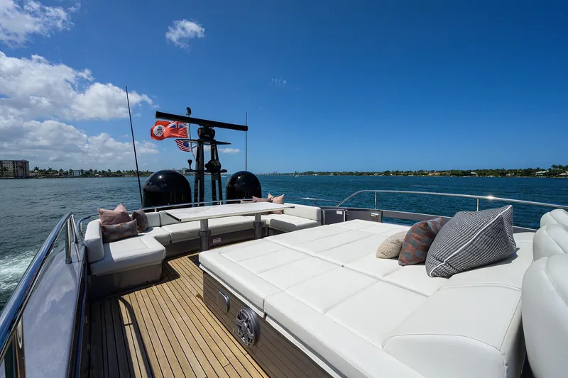 Slide: The Image of Luxurious 2022 Pershing 9X yacht deck with plush seating and ocean view. - 25