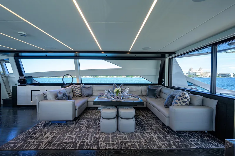 Slide: The Image of Luxurious 2022 Pershing 9X yacht deck with seating, table, and waterfront view. - 32
