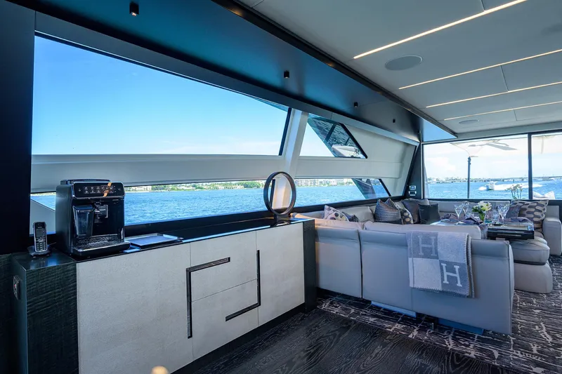 Slide: The Image of Luxurious interior of 2022 Pershing 9X yacht with elegant dining area and panoramic windows. - 38
