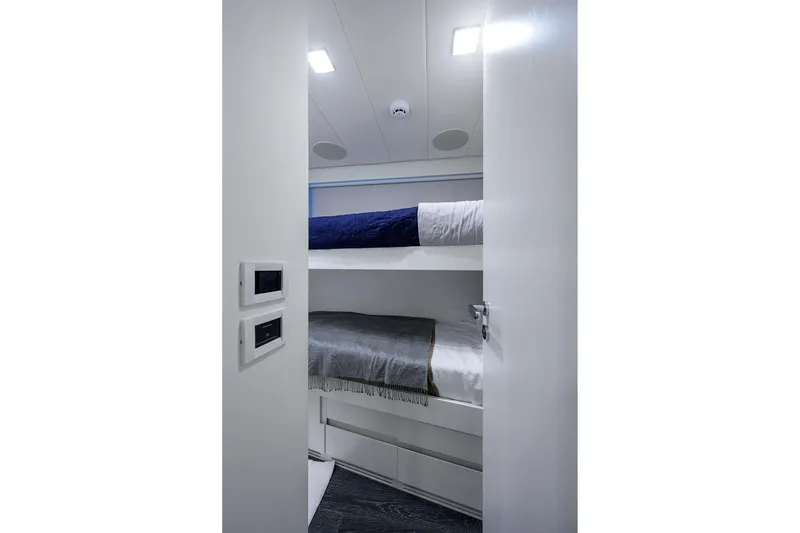 Slide: The Image of Luxurious twin bedroom interior on 2022 Pershing 9X yacht, featuring modern design and ambient lighting. - 77