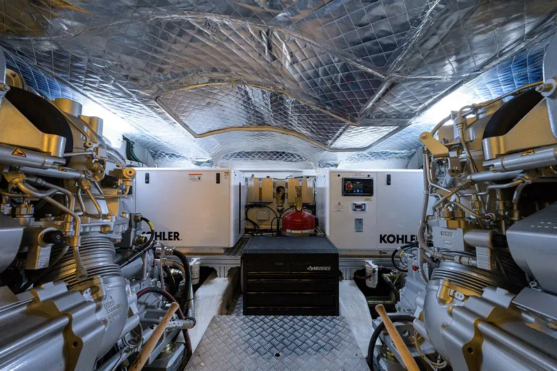 Slide: The Image of Engine room of 2022 Pershing 9X yacht with advanced machinery and control panels. - 88