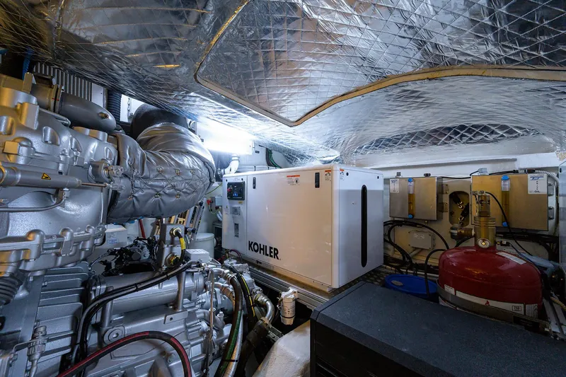 Slide: The Image of Engine room of 2022 Pershing 9X yacht with control panels and machinery. - 89