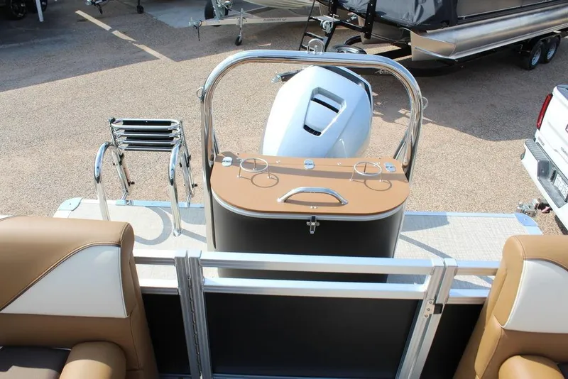 Slide: The Image of 2026 Avalon Venture 85 Quad Lounger boat interior with motor and seating area. - 16