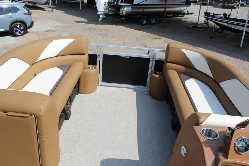 Slide: The Image of 2026 Avalon Venture 85 Quad Lounger 23 FT with tan and white seating, docked outdoors. - 18
