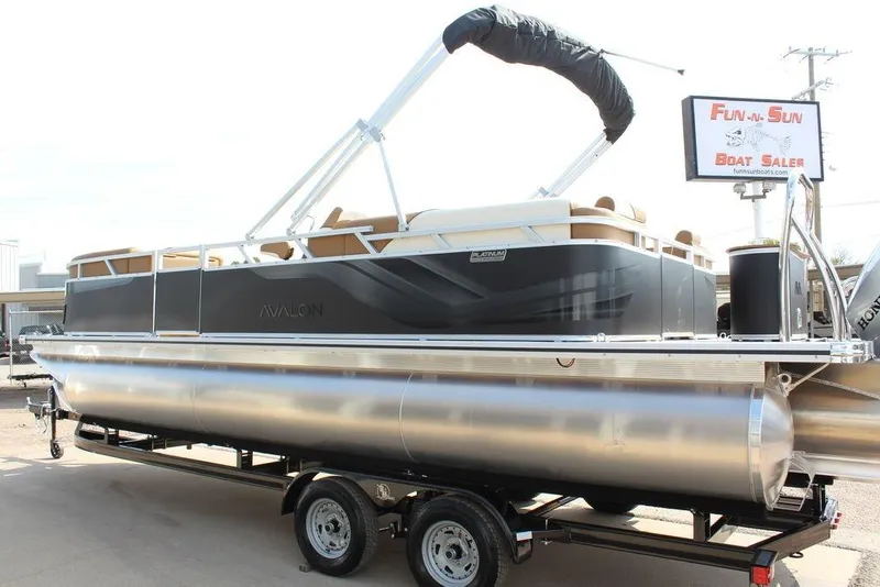 Slide: The Image of 2026 Avalon Venture 85 Quad Lounger 23 FT pontoon boat on trailer at dealership. - 2